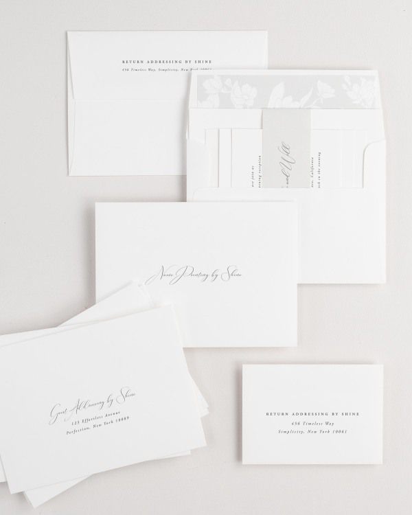 Alyssa wedding invitation envelopes with guest addressing, return addressing, and name printing services. Inner envelope features a magnolia liner and soft gray belly band.