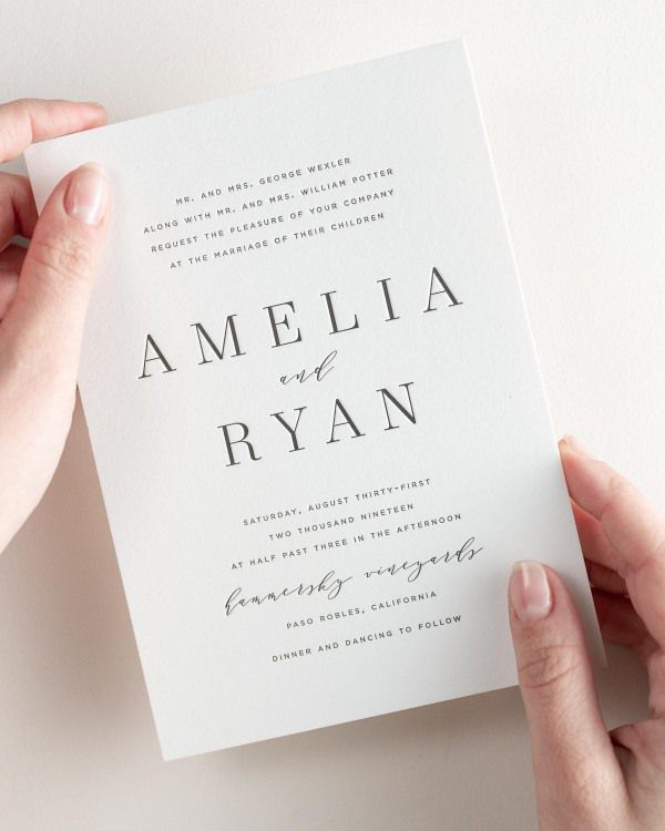 Bride holding her 5x7” Amelia letterpress wedding invitation.