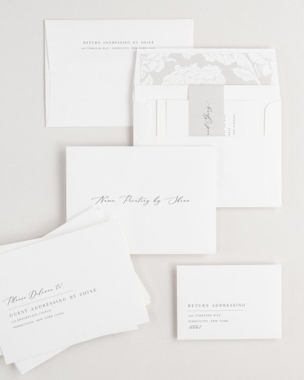 Annalena wedding invitation envelopes with guest addressing, return addressing, and name printing services. Inner envelope features a blooms liner and stone belly band.