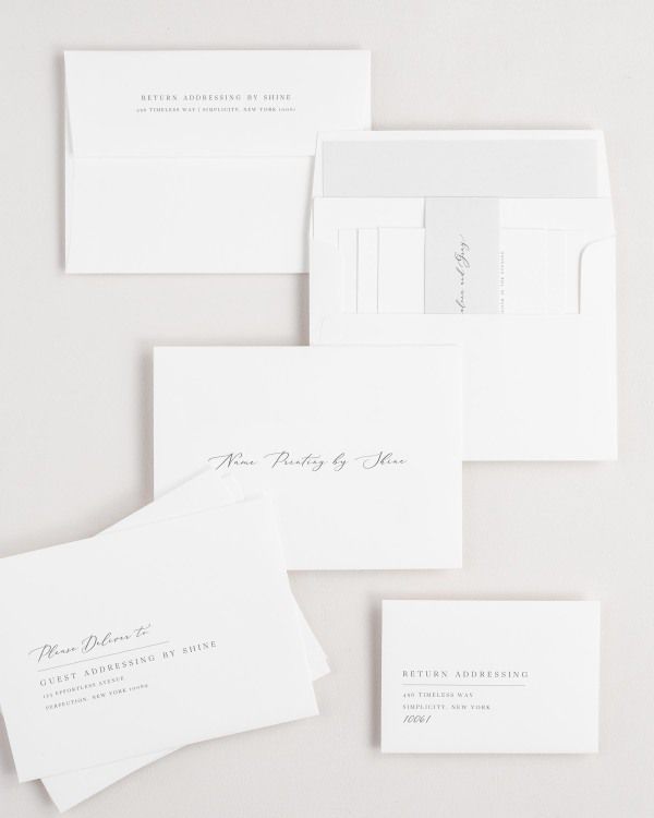 Annalena wedding invitation envelopes with guest addressing, return addressing, and name printing services. Inner envelope features a solid liner and soft gray belly band.