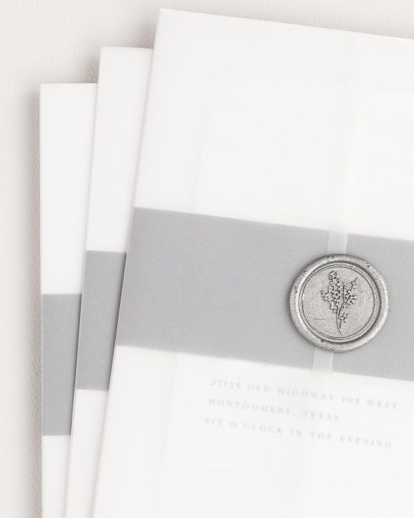 Annalena wedding invitation with a slate belly band, translucent vellum jacket, and silver posy wax seal.