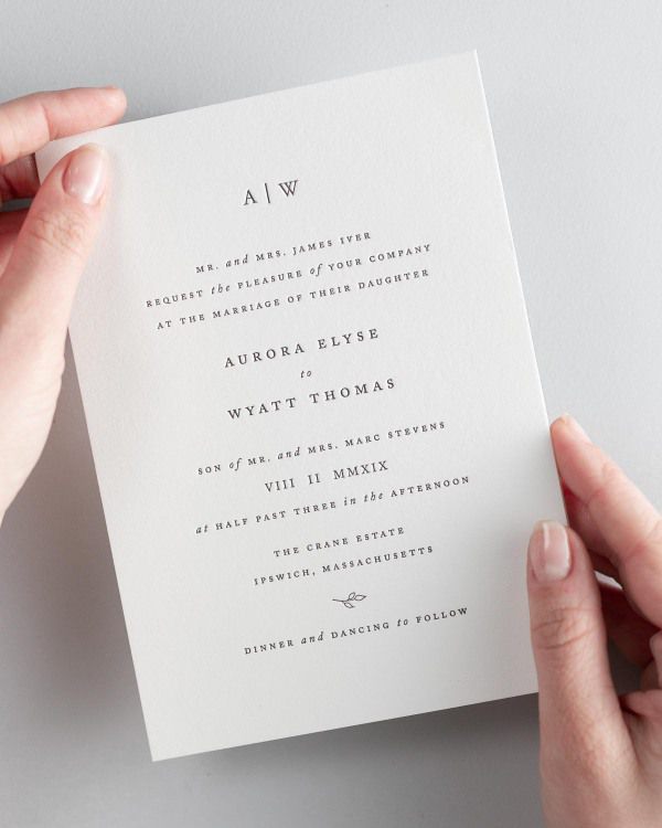 Bride holding her 5x7” Aurora letterpress wedding invitation.