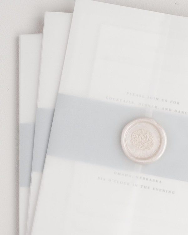 Austin wedding invitation with a cloud belly band, translucent vellum jacket, and pearl florette wax seal.