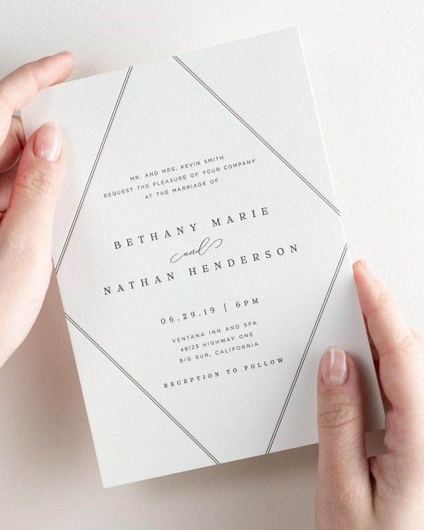 Bride holding her 5x7” Bethany letterpress wedding invitation.
