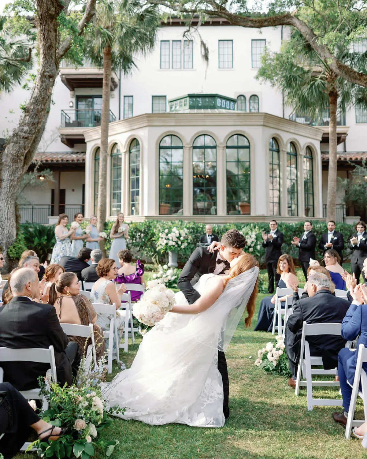 The Bride and Groom Share a Kiss on the Way Back Down the Aisle