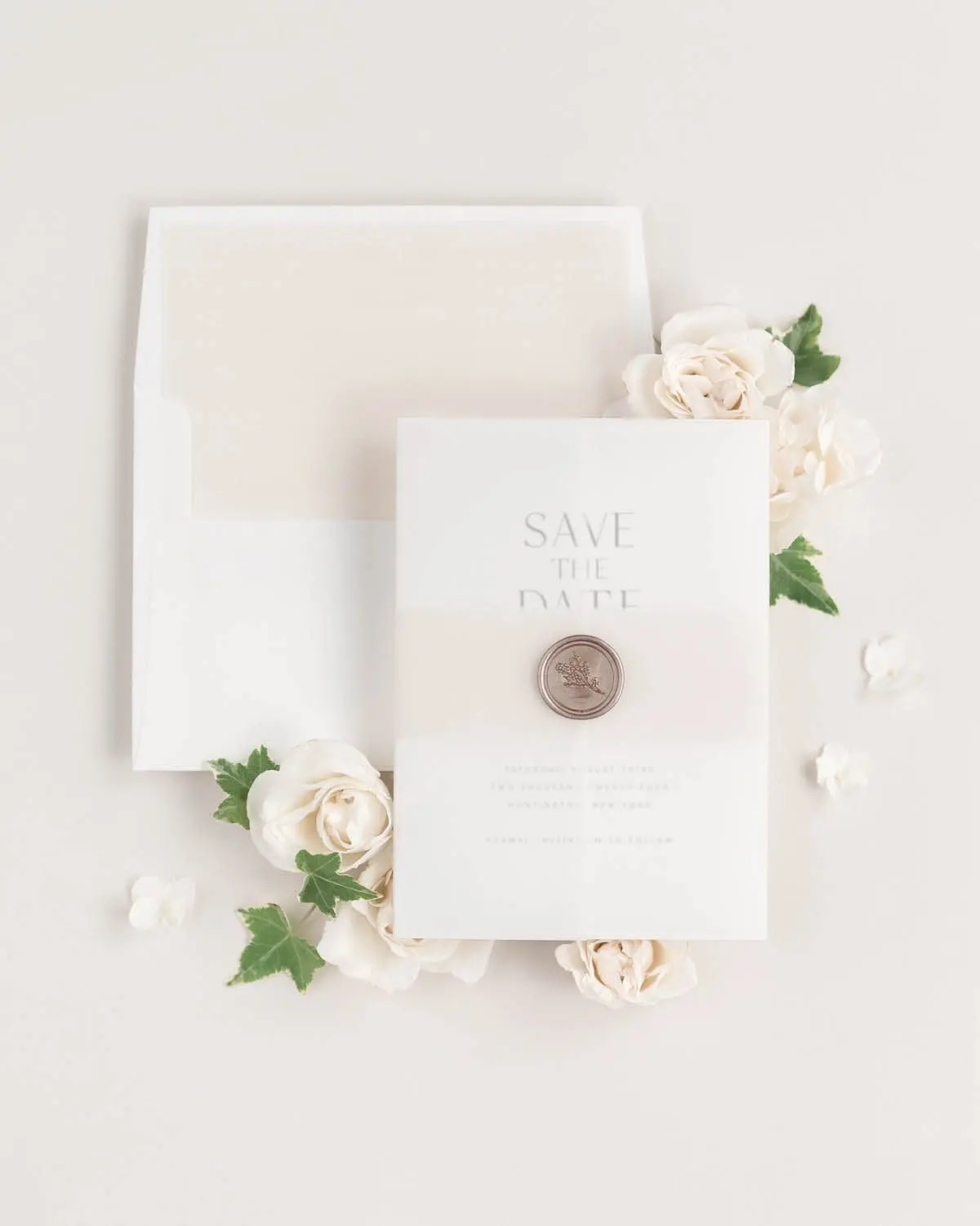 Naomi Save the Dates styled with Nude belly band, vellum jacket, and bronze wax seal