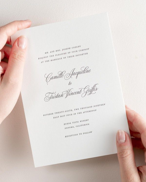 Bride holding her 5x7” Camille letterpress wedding invitation.