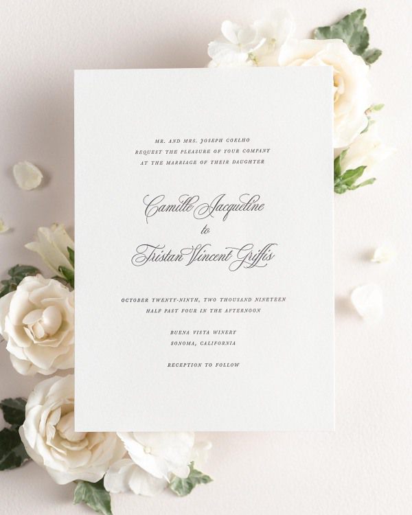 Camille letterpress wedding invitation styled with pretty florals.
