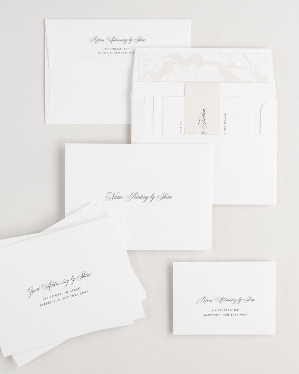 Camille wedding invitation envelopes with guest addressing, return addressing, and name printing services. Inner envelope features a blooms liner and nude belly band.
