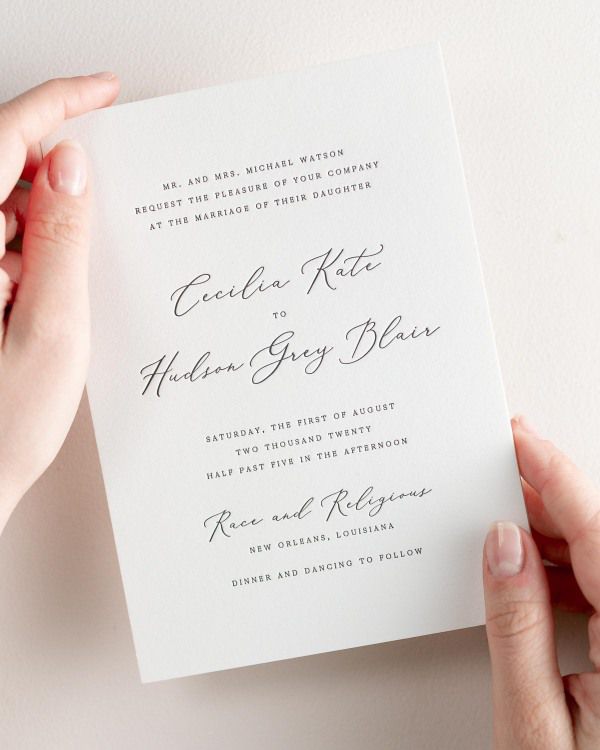 Bride holding her 5x7” Cecilia letterpress wedding invitation.