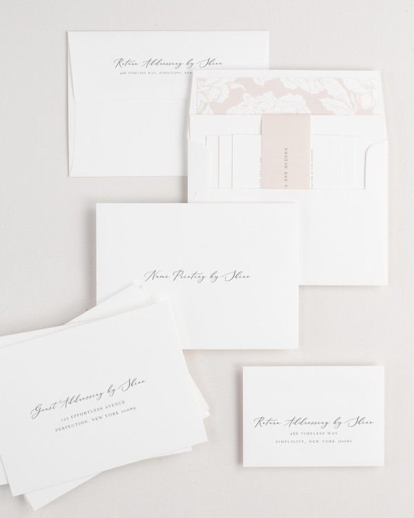 Cecilia wedding invitation envelopes with guest addressing, return addressing, and name printing services. Inner envelope features a blooms liner and rose gold belly band.