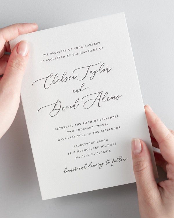 Bride holding her 5x7” Chelsea letterpress wedding invitation.