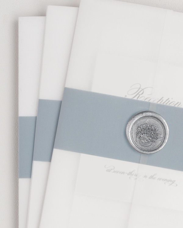 Classic Script wedding invitation with a mineral belly band, translucent vellum jacket, and silver florette wax seal.