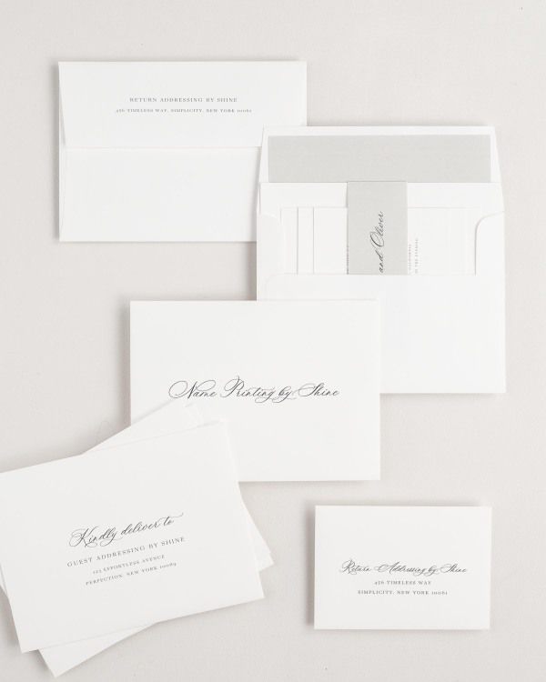 Claudia wedding invitation envelopes with guest addressing, return addressing, and name printing services. Inner envelope features a solid liner and stone belly band.