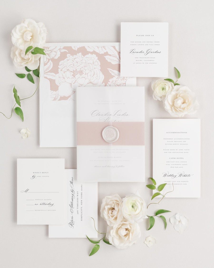 Claudia wedding invitation with a rosewater belly band, translucent vellum jacket, and wax seal.