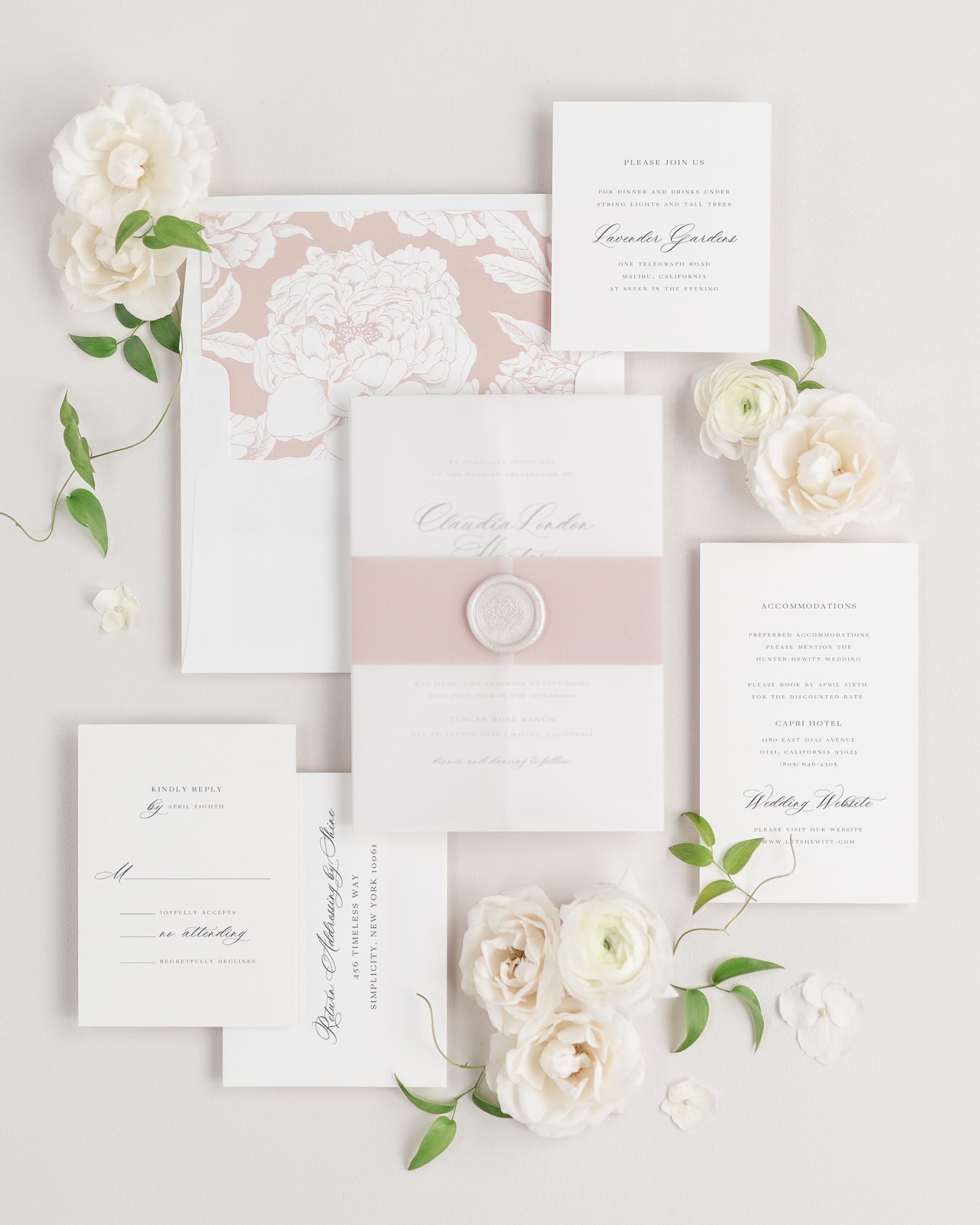 Claudia wedding invitation with a rosewater belly band, translucent vellum jacket, and wax seal.
