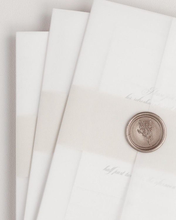 Danielle wedding invitation with a nude belly band, translucent vellum jacket, and bronze posy wax seal.