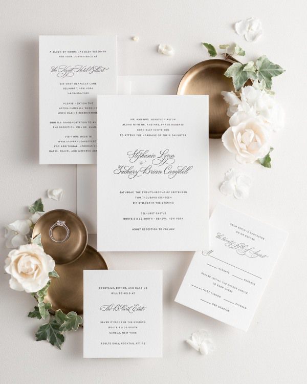 All pieces of the Delicate Elegance letterpress wedding invitation suite, including the invitation, small and large enclosures, and response card.