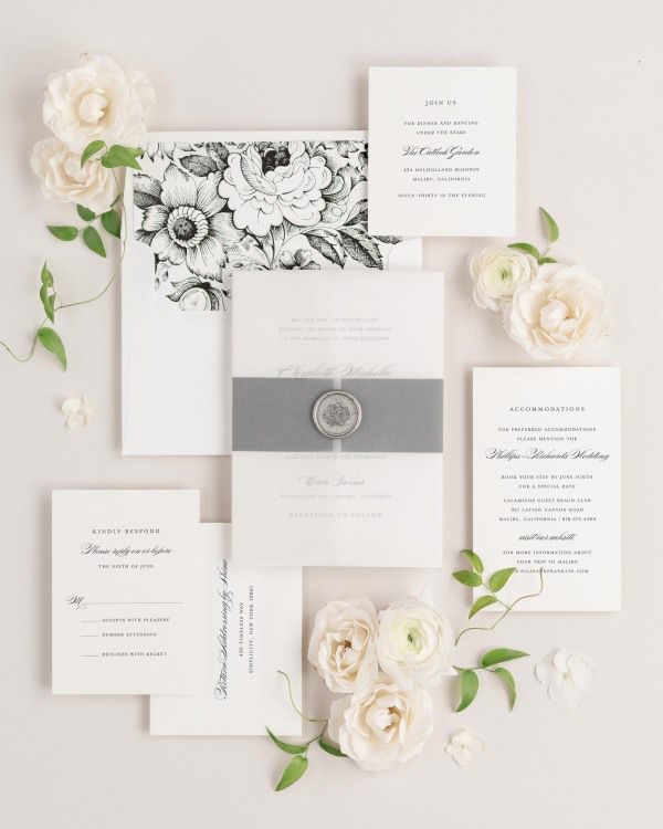 Elizabeth wedding invitation with a black belly band, translucent vellum jacket, and silver florette wax seal.