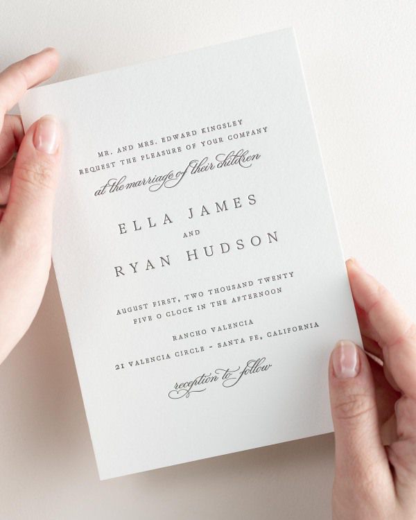 Bride holding her 5x7” Ella letterpress wedding invitation.