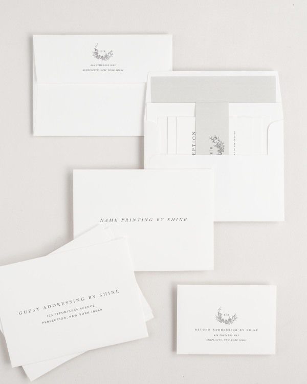 Emily wedding invitation envelopes with guest addressing, return addressing, and name printing services. Inner envelope features a solid liner and stone belly band.