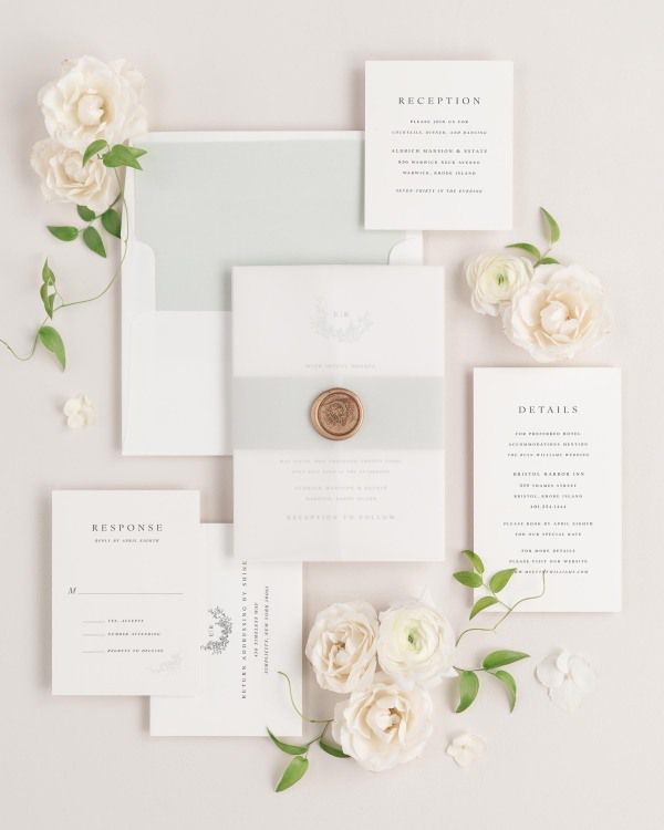 Emily wedding invitation with a sea salt belly band, translucent vellum jacket, and gold wreath wax seal.