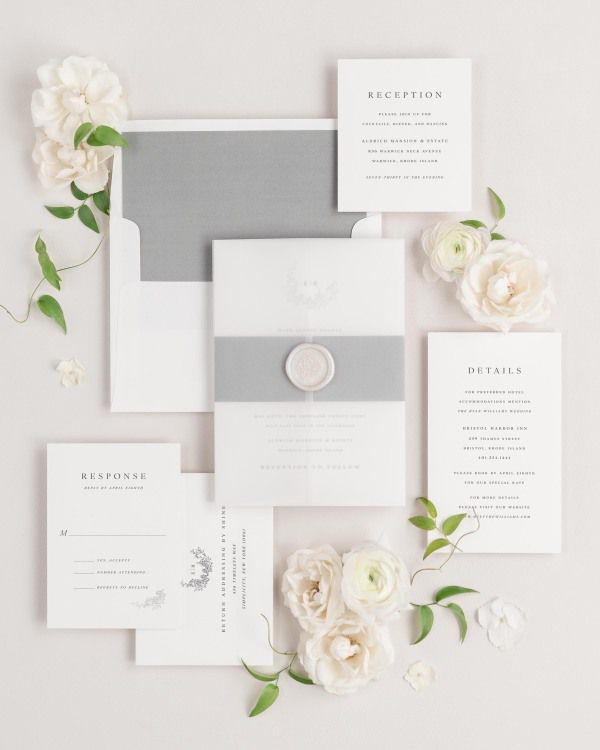 Emily wedding invitation with a slate belly band, translucent vellum jacket, and pearl florette wax seal.