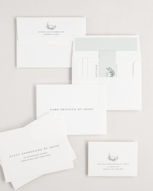 Emily wedding invitation envelopes with guest addressing, return addressing, and name printing services. Inner envelope features a solid liner and sea salt belly band.