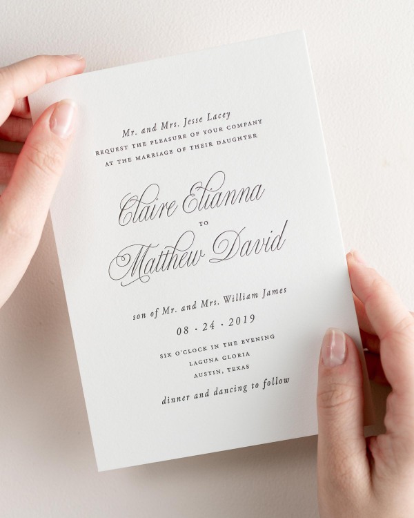 Bride holding her 5x7” Garden Elegance letterpress wedding invitation.