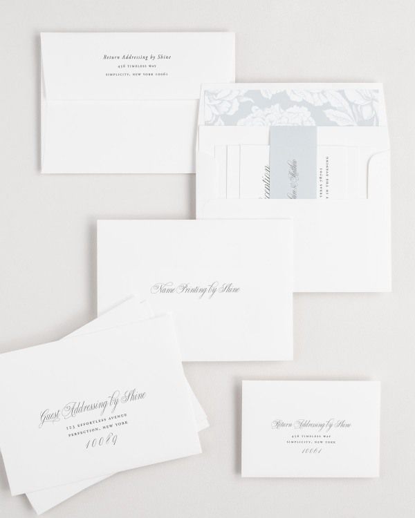 Garden Elegance wedding invitation envelopes with guest addressing, return addressing, and name printing services. Inner envelope features a blooms liner and cloud belly band.