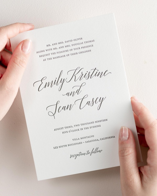 Bride holding her 5x7” Garden Romance letterpress wedding invitation.