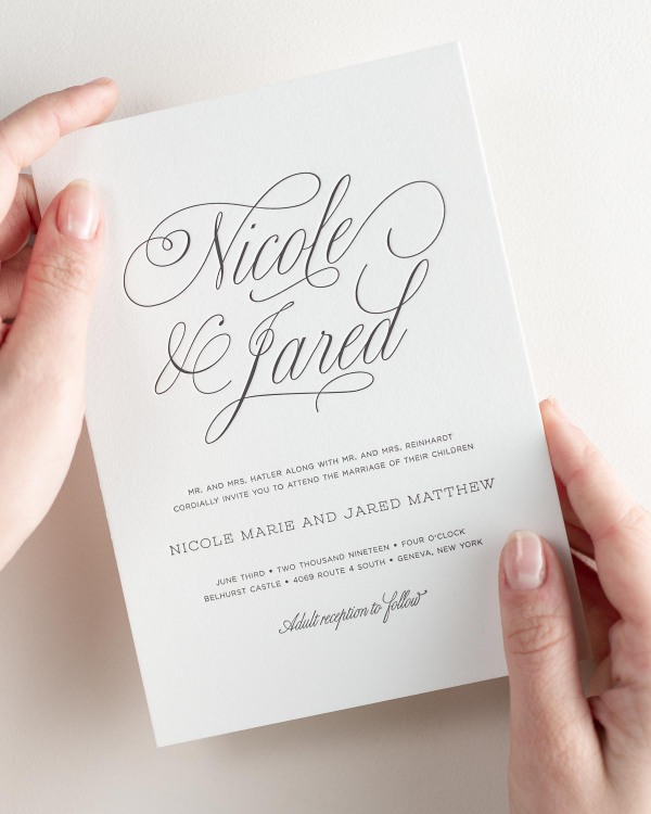 Bride holding her 5x7” Garden Script letterpress wedding invitation.