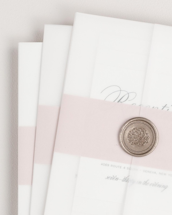 Garden Script wedding invitation with a vintage blush belly band, translucent vellum jacket, and bronze florette wax seal.
