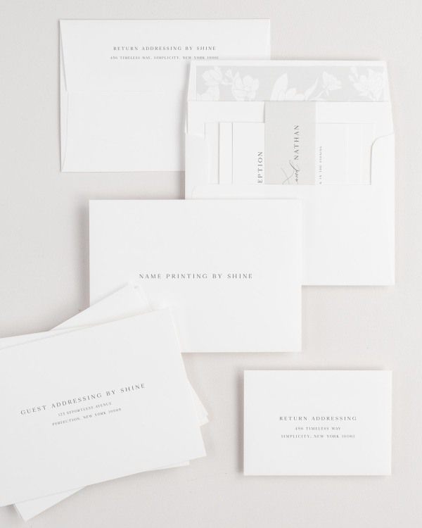 Gemma wedding invitation envelopes with guest addressing, return addressing, and name printing services. Inner envelope features a magnolia liner and soft gray belly band.