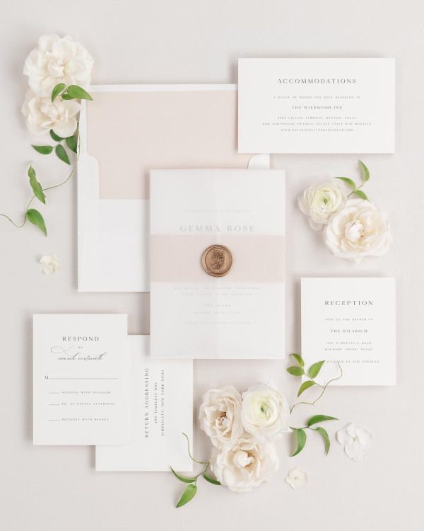 Gemma wedding invitations flat lay with rose gold solid liner, rose gold belly band, translucent vellum jacket, and gold posy wax seal.