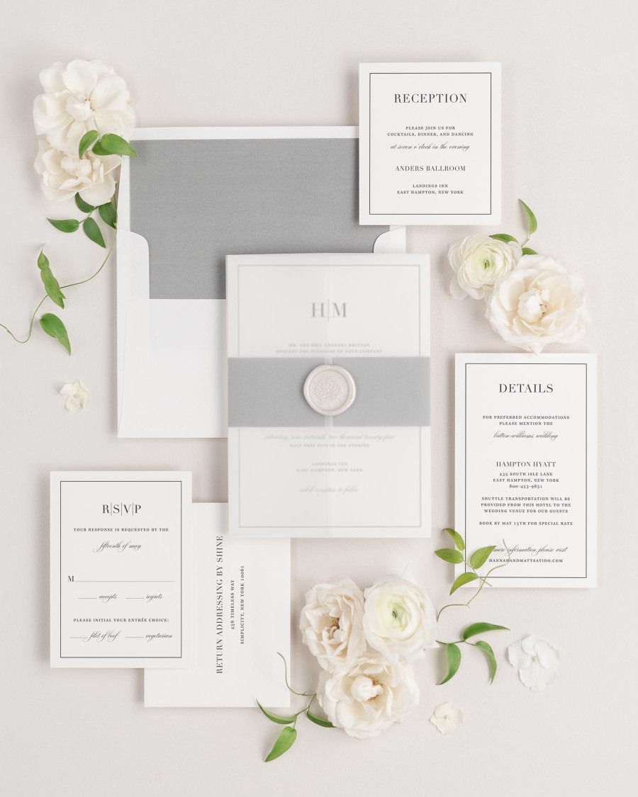 Glam Monogram wedding invitations flat lay with slate solid liner, translucent vellum jacket, and pearl florette wax seal.