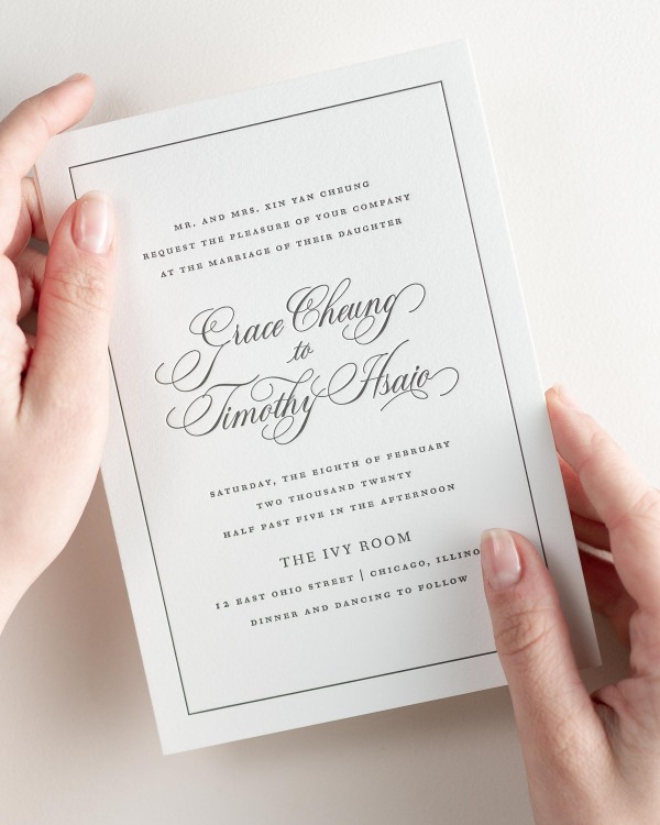 Bride holding her 5x7” Grace letterpress wedding invitation.