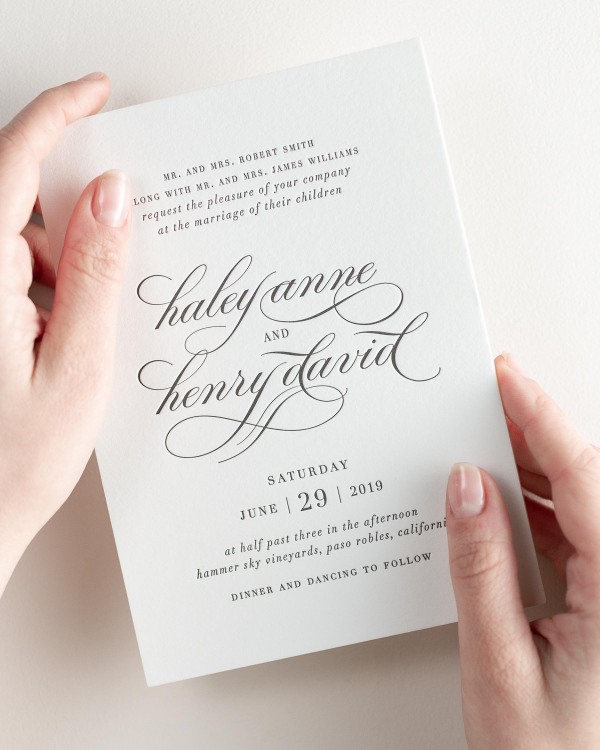 Bride holding her 5x7” Haley letterpress wedding invitation.