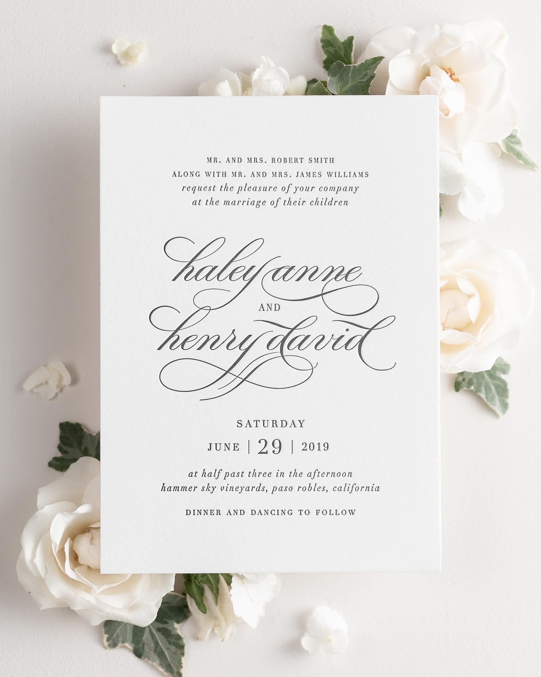 Haley letterpress wedding invitation styled with pretty florals.