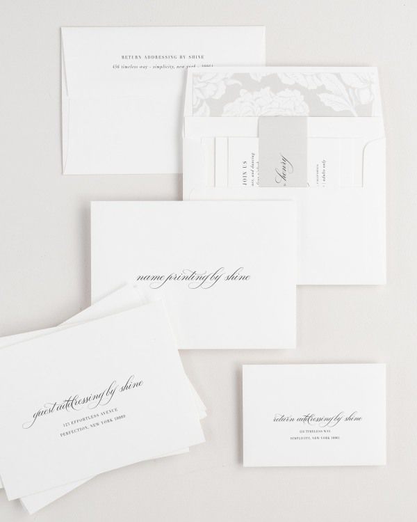 Haley wedding invitation envelopes with guest addressing, return addressing, and name printing services. Inner envelope features a blooms liner and stone belly band.