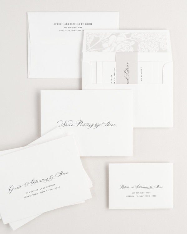 Hazel wedding invitation envelopes with guest addressing, return addressing, and name printing services. Inner envelope features a hydrangea liner and stone belly band.