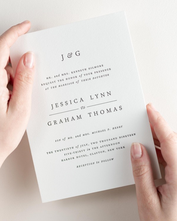 Bride holding her 5x7” Jessica letterpress wedding invitation.