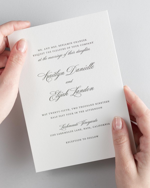 Bride holding her 5x7” Kaitlyn letterpress wedding invitation.