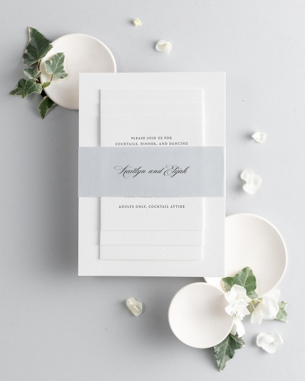 Kaitlyn letterpress wedding invitation suite stacked and wrapped with a personalized Cloud belly band.