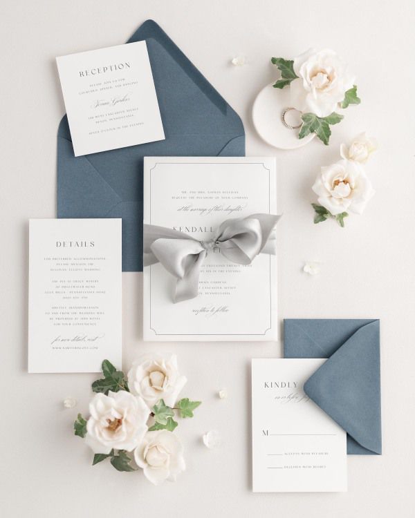 Wedding invitations with silk ribbon and chambray blue envelope
