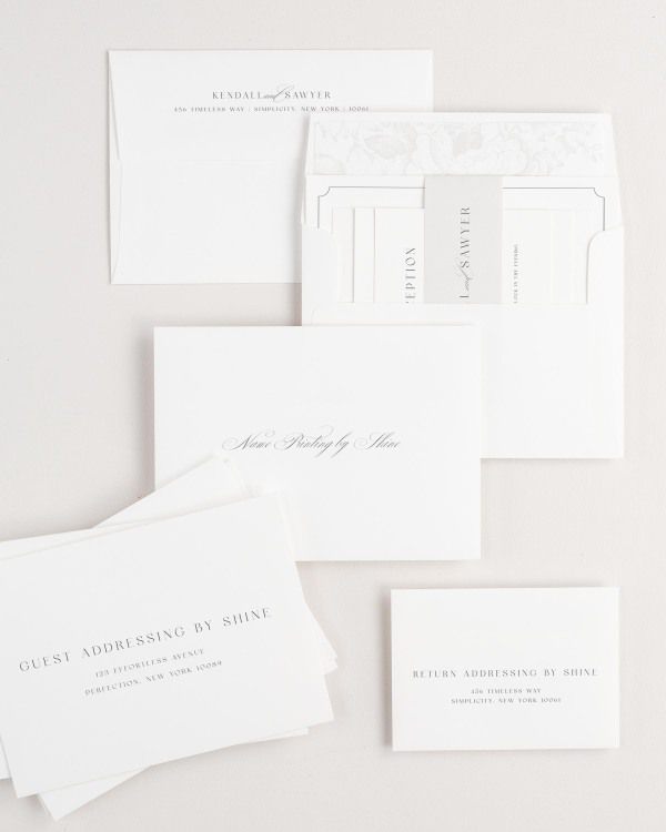 Kendall wedding invitation envelopes with guest addressing, return addressing, and name printing services. Inner envelope features a garden rose liner and soft gray belly band.