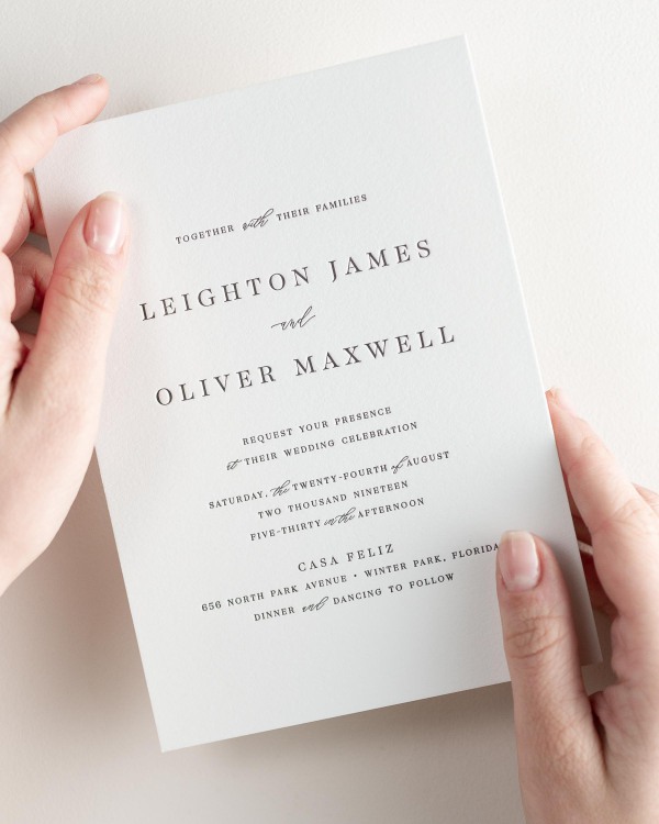 Bride holding her 5x7” Leighton letterpress wedding invitation.