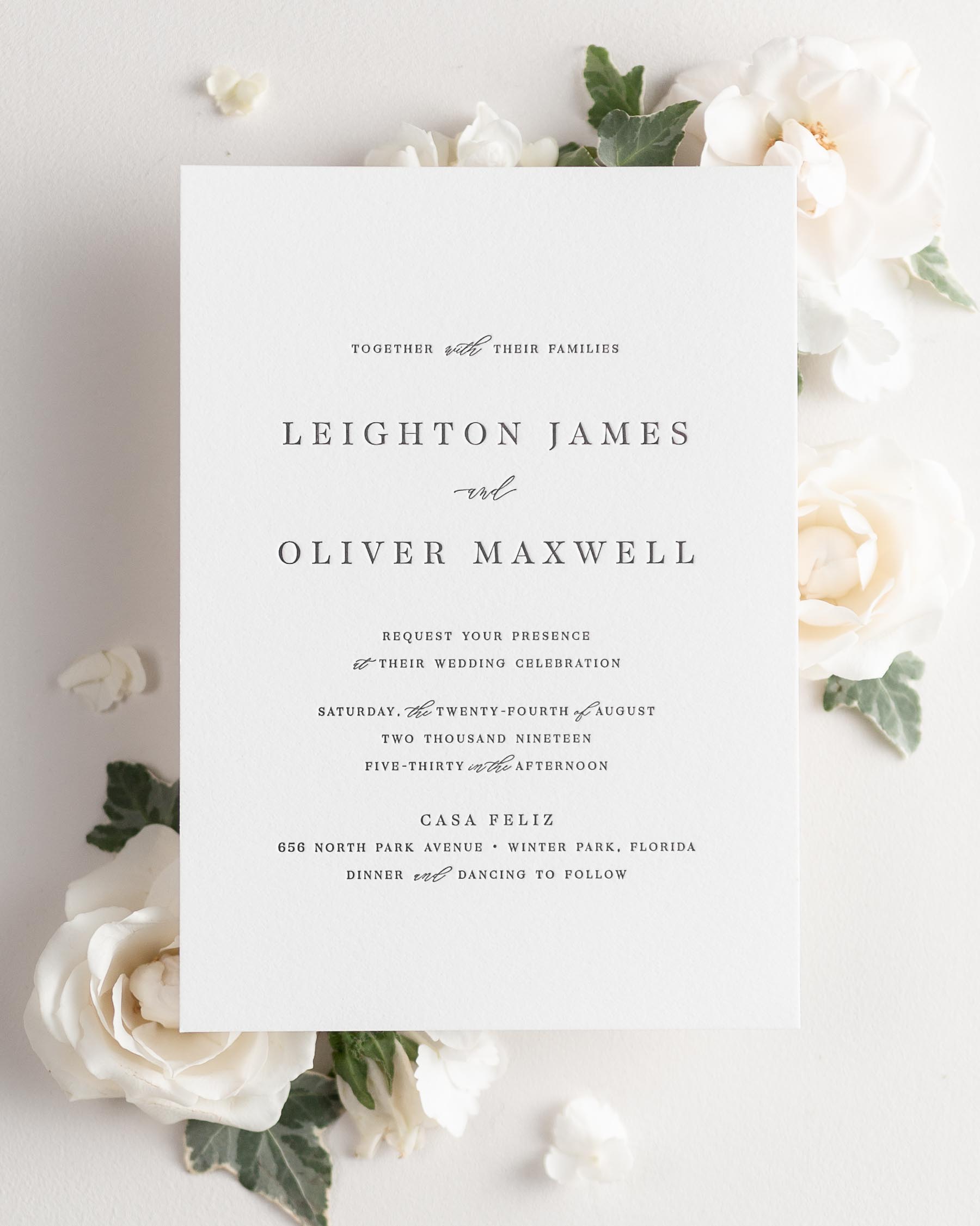 Leighton letterpress wedding invitation styled with pretty florals.