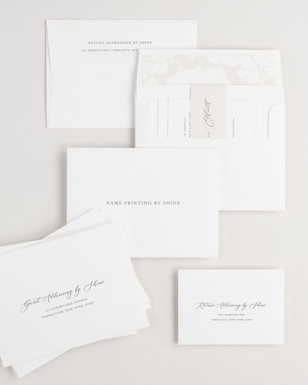 Lucille wedding invitation envelopes with guest addressing, return addressing, and name printing services. Inner envelope features a blooms liner and nude belly band.