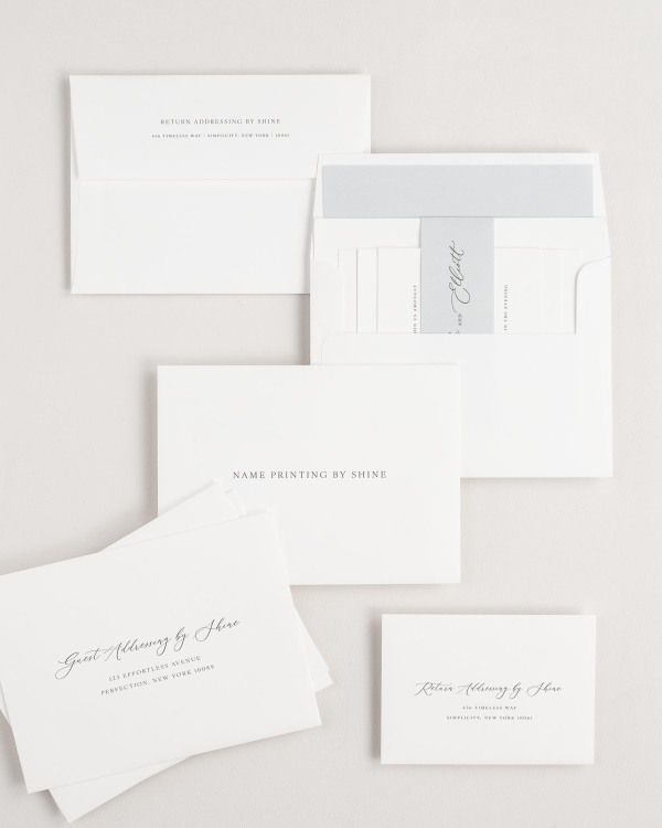 Lucille wedding invitation envelopes with guest addressing, return addressing, and name printing services. Inner envelope features a solid liner and cloud belly band.